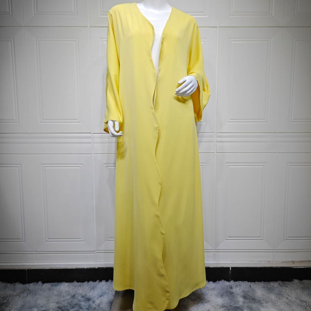 Front view of lemon yellow open abaya showing V-neckline and bound edge finish