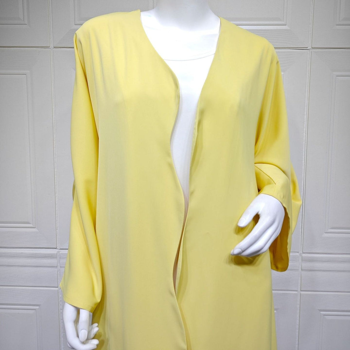 Wide relaxed sleeve detail with turn-up cuff on collarless open abaya