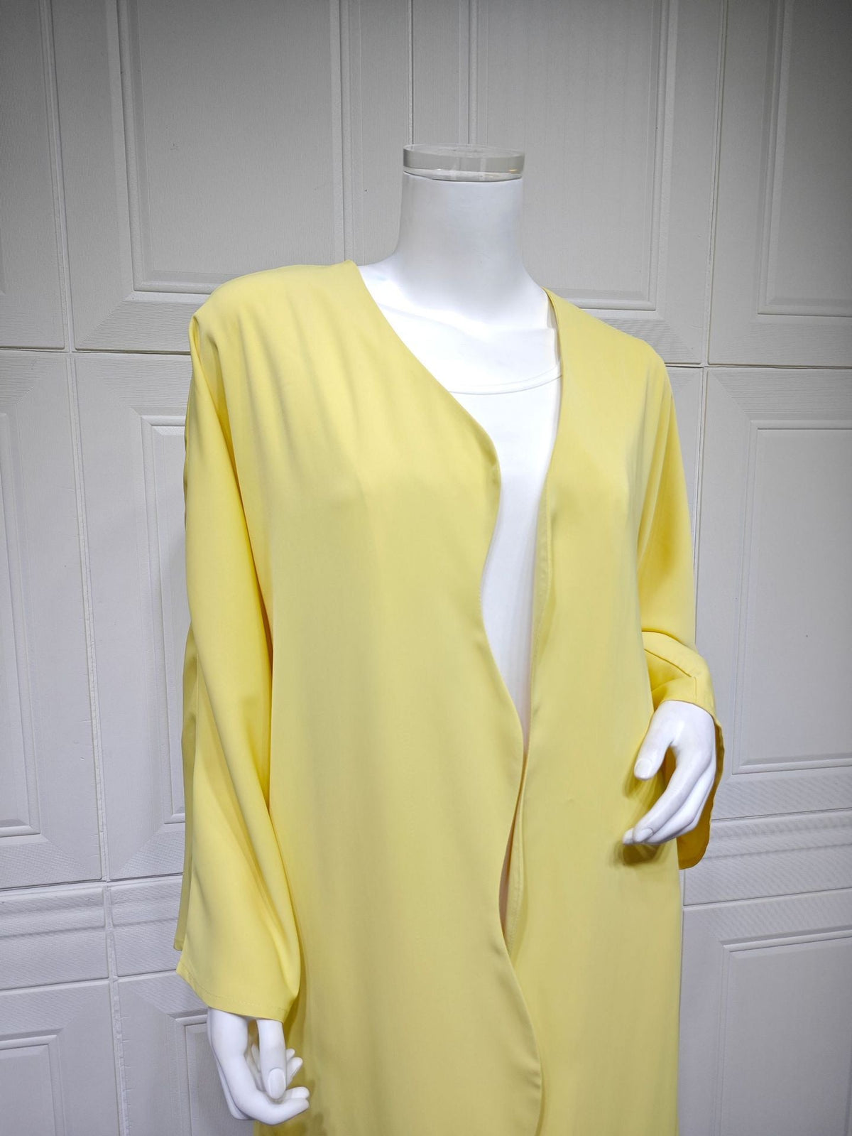 Floor-length A-line silhouette of lightweight lemon yellow open front abaya