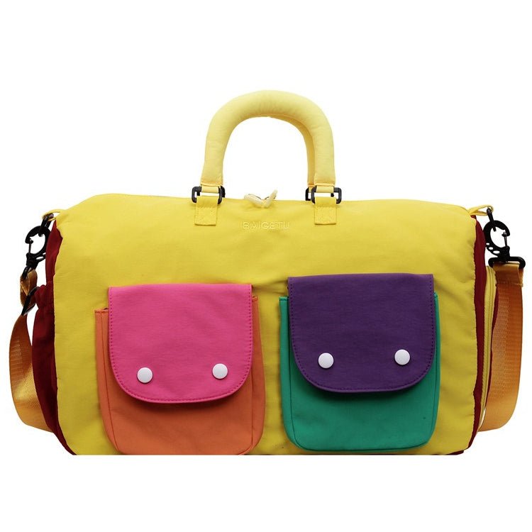 Colorblock duffel bag worn crossbody with adjustable strap