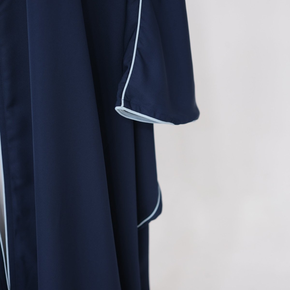 Full-length front view of contrast piped nida abaya in tonal colourway
