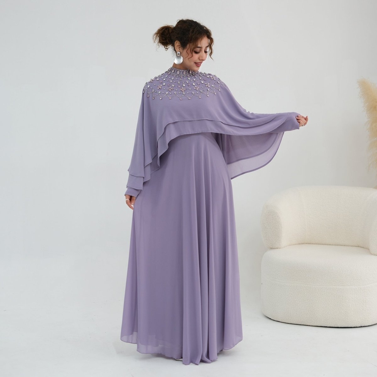 Full-length side profile of A-line chiffon maxi dress with cape overlay