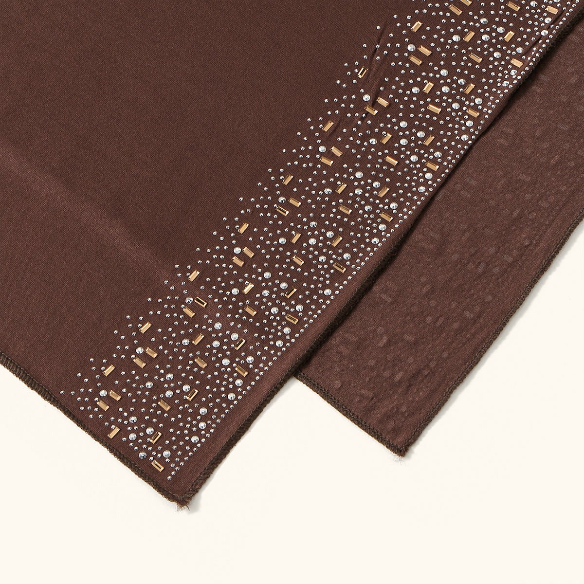Close-up of gold baguette and clear silver rhinestone border on embellished hijab scarf