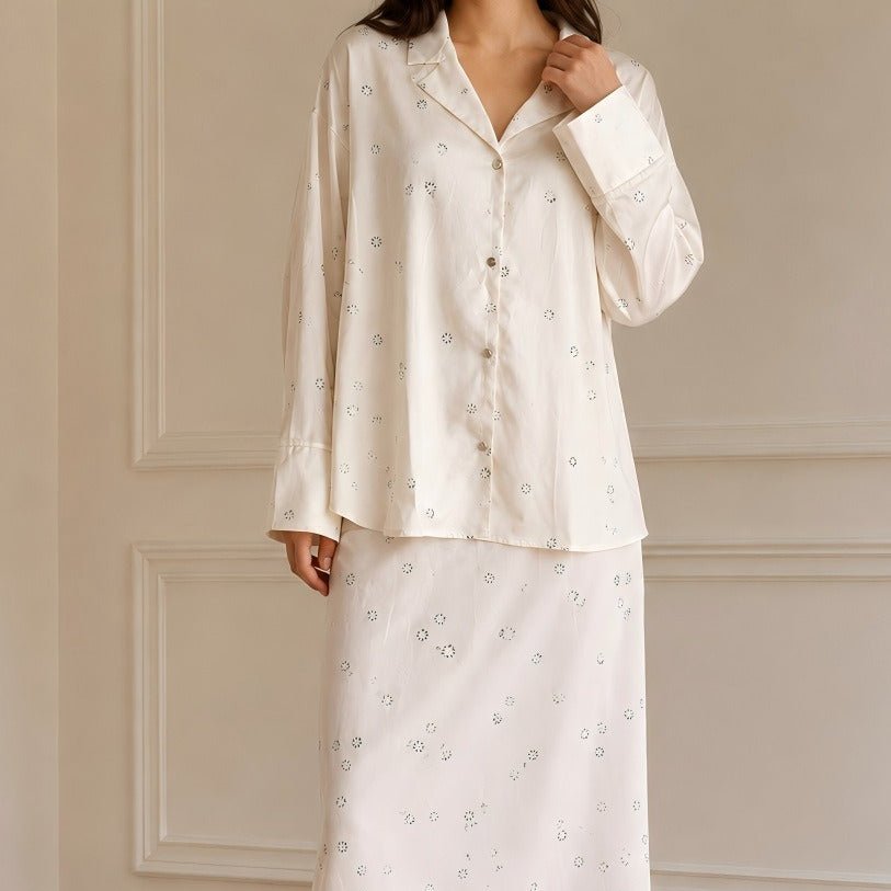 Close-up of daisy floral print detail on ivory fabric shirt and skirt co-ord