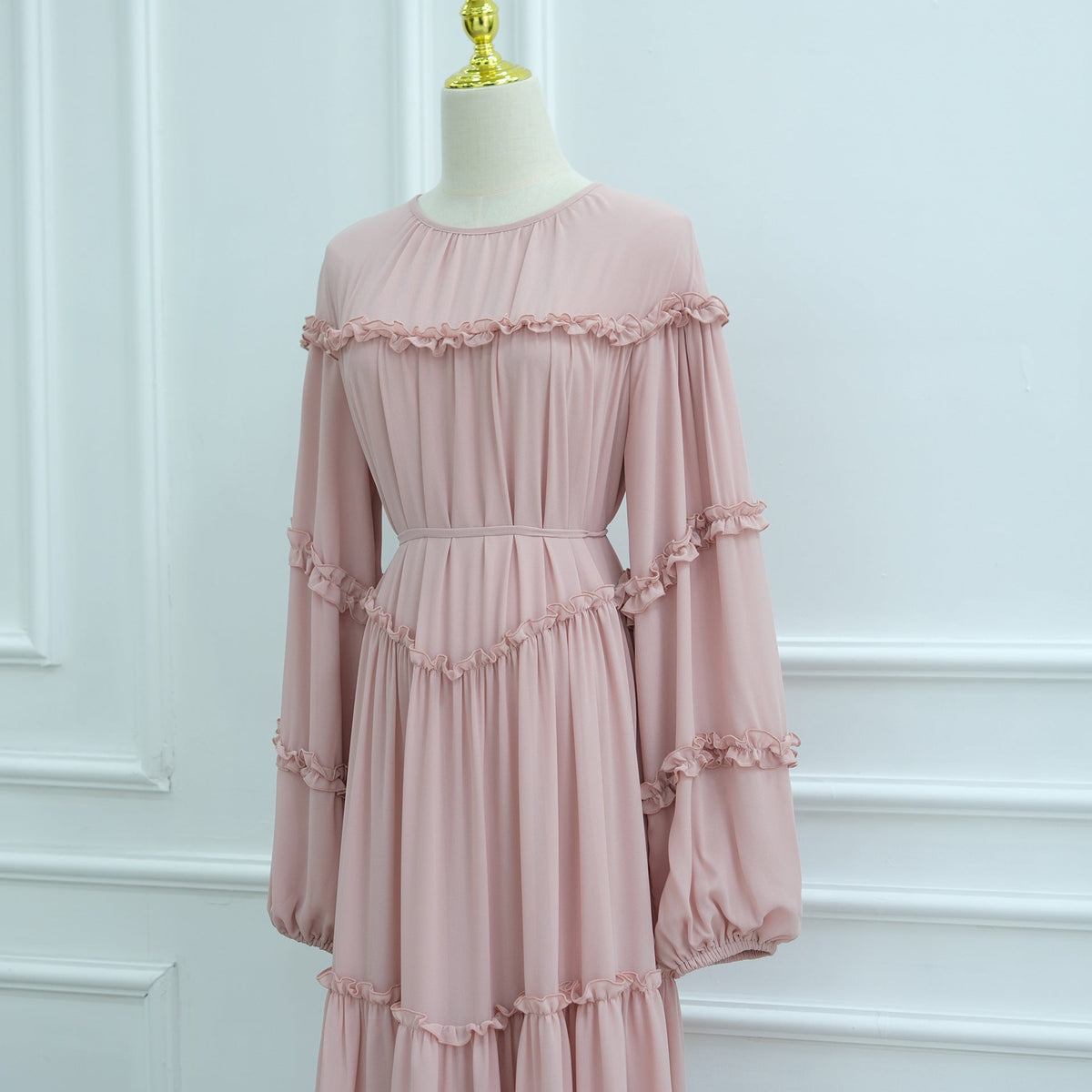 Waist tie detail on tiered ruffle modest maxi dress creating defined silhouette