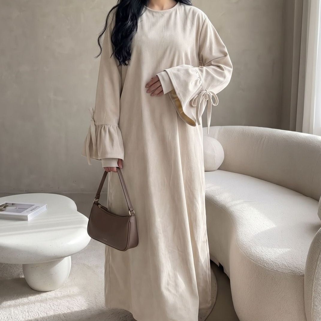 Close-up of soft fabric and clean neckline on solid colour abaya