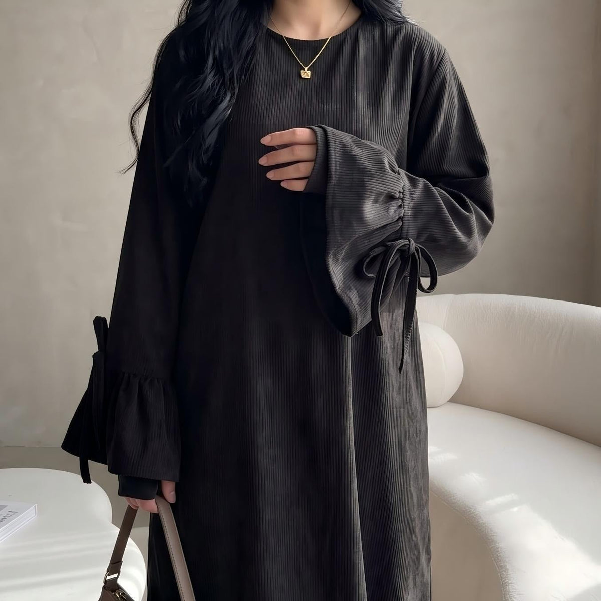 Side profile of flowing solid colour maxi abaya showing fluid drape