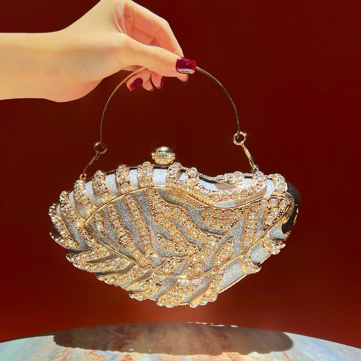 Detachable gold-tone chain strap on the vintage rhinestone clutch bag
