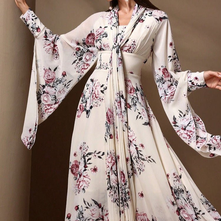 Detail of wide kimono sleeves with extended wing panels and empire waist tie-belt