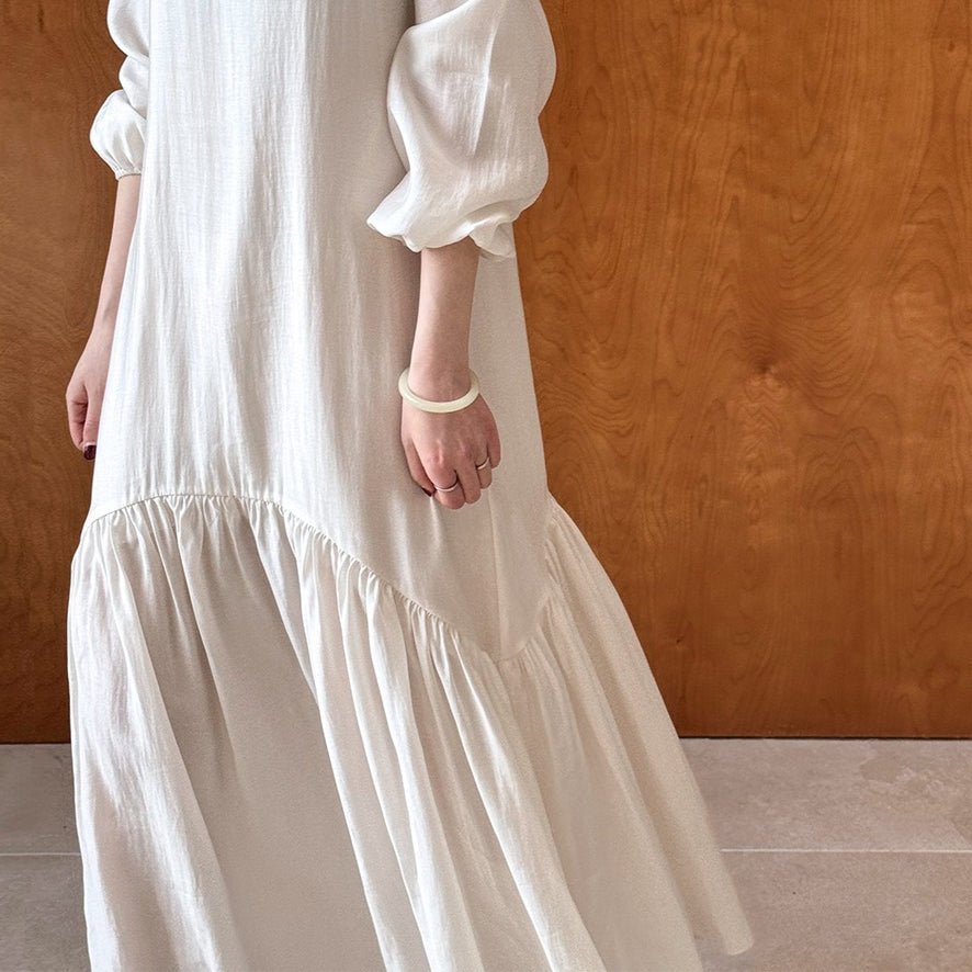 Side view of french-inspired mermaid maxi dress showing flared ruffle hem