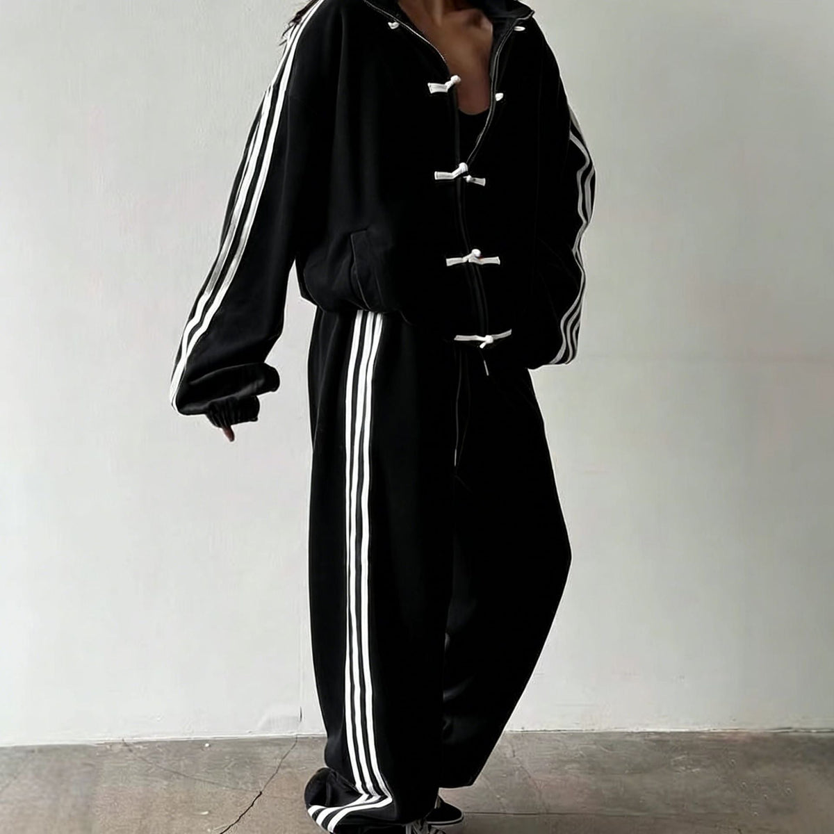 Contrast triple-stripe detail along the tracksuit sleeve