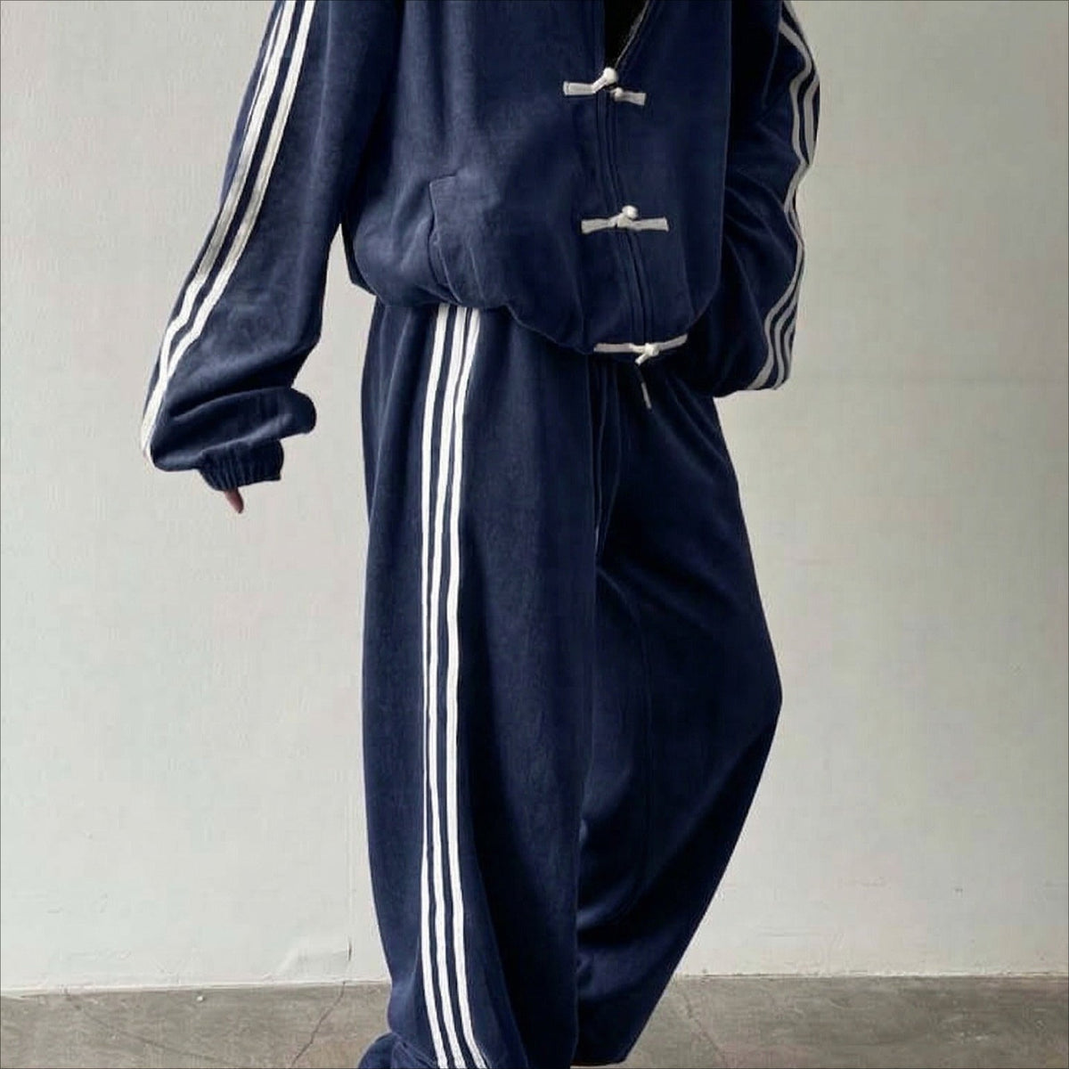 Fabric drape detail of the modest track suit jacket