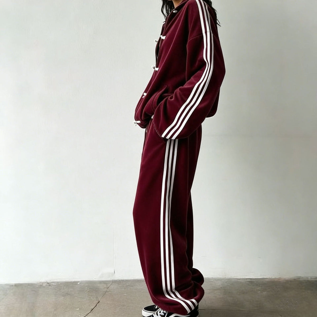 Model walking in the frog-button tracksuit co-ord