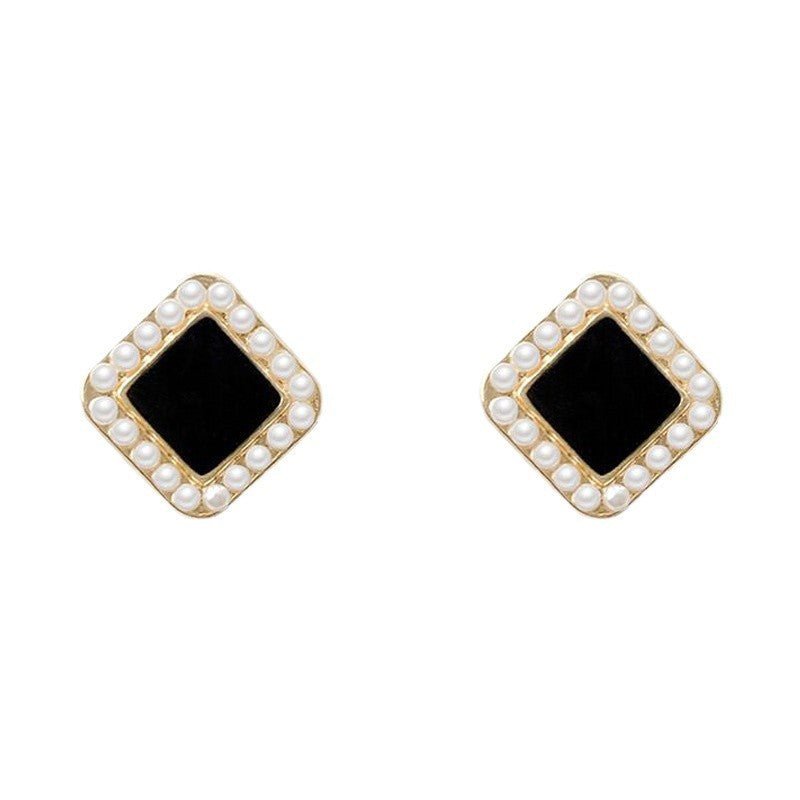 Close-up of beaded border detail on square frame pearl stud earrings