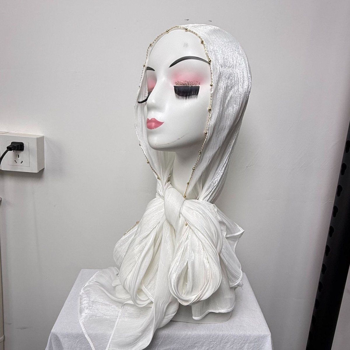 Shimmer crinkle satin hijab draped over shoulder showing fluid movement