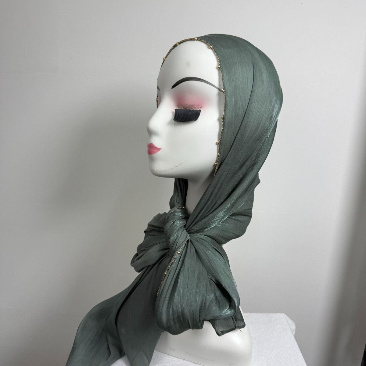 Side view of fluid crinkle satin hijab with metallic bead chain trim