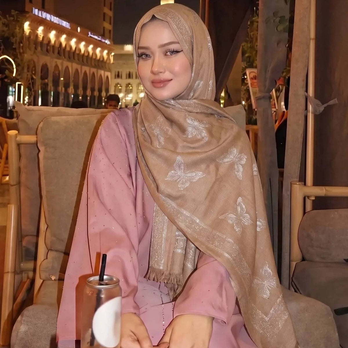 Jacquard hijab folded flat showing woven gold pattern and tassels