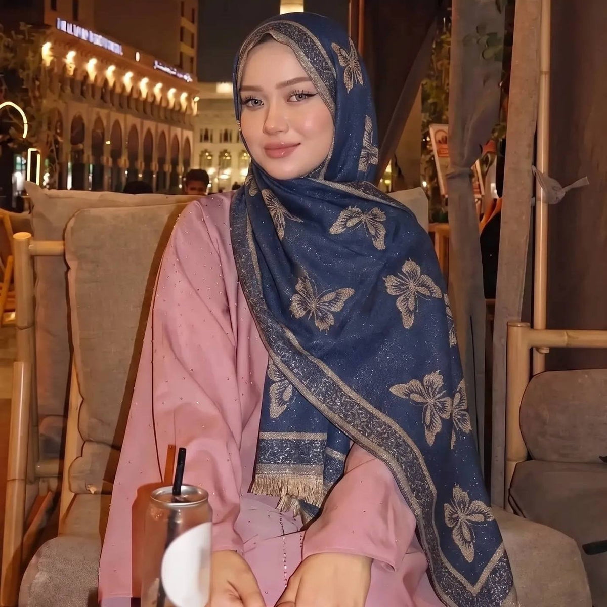 Overhead flat lay of gold jacquard woven hijab scarf