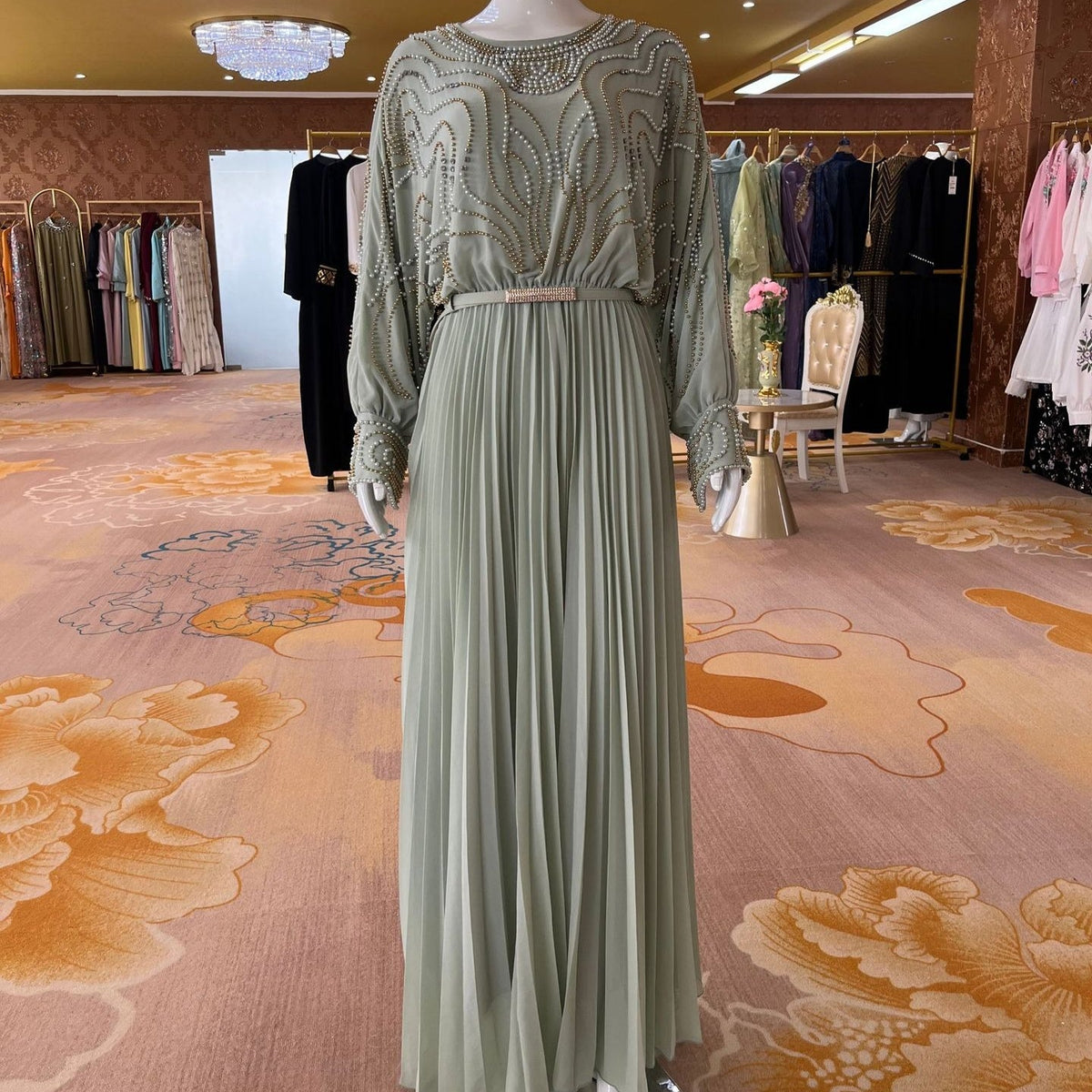 Elasticated waist with beaded chain belt transitioning to fine pleated skirt