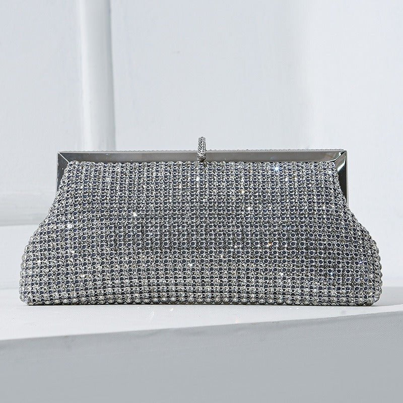 Model holding rhinestone clutch as a hand-carry evening bag