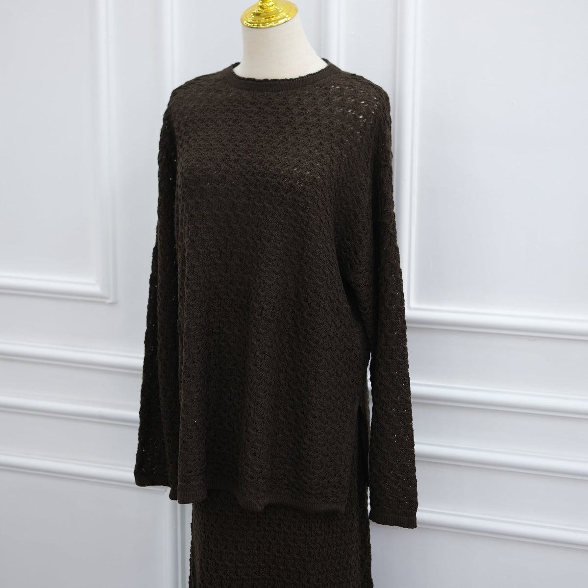 Styled flat lay of crochet knit sweater and maxi skirt co-ord set