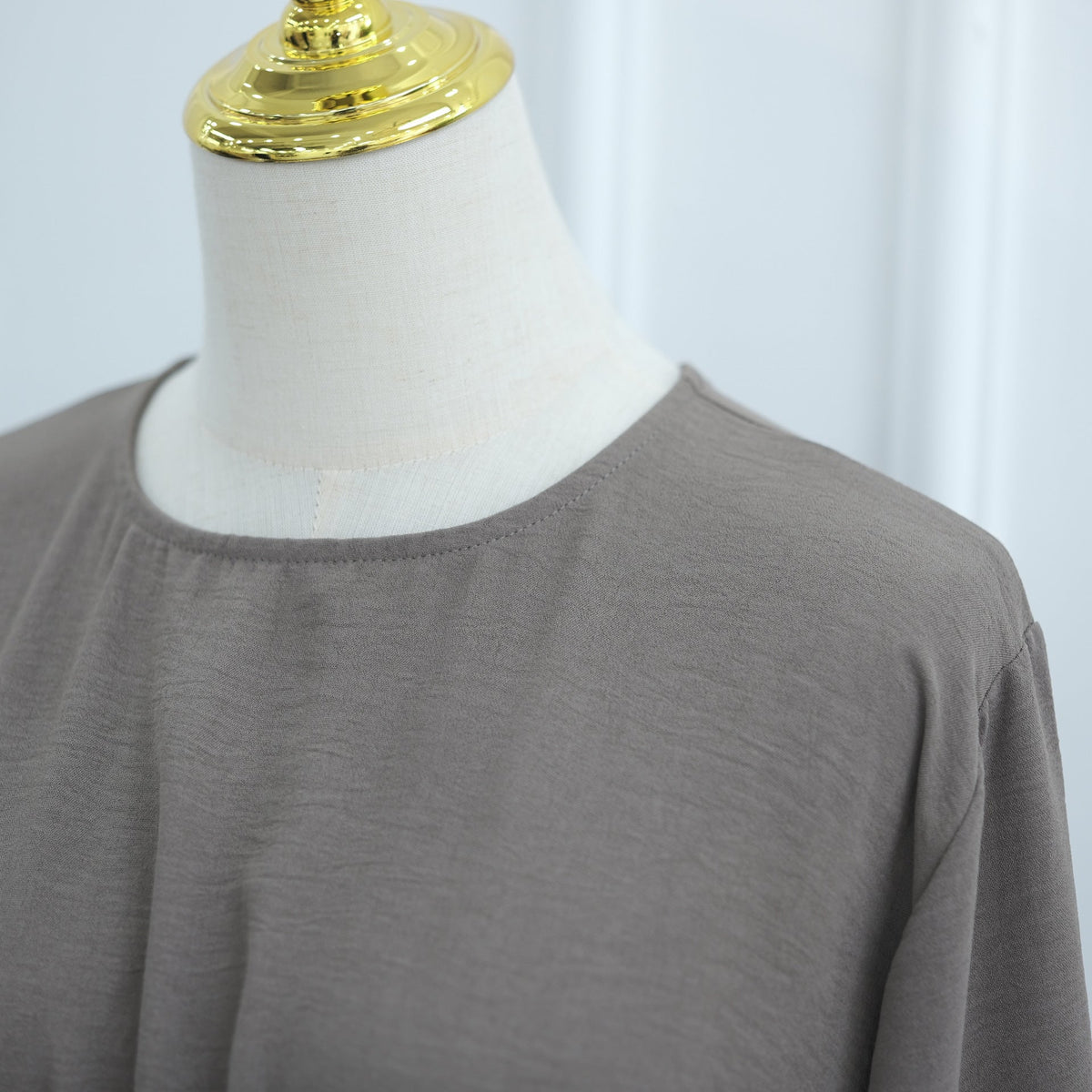 Bell cuff sleeve gently flaring at the wrist