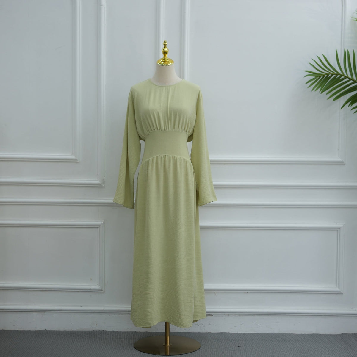 Full length side profile of A-line crinkle maxi dress