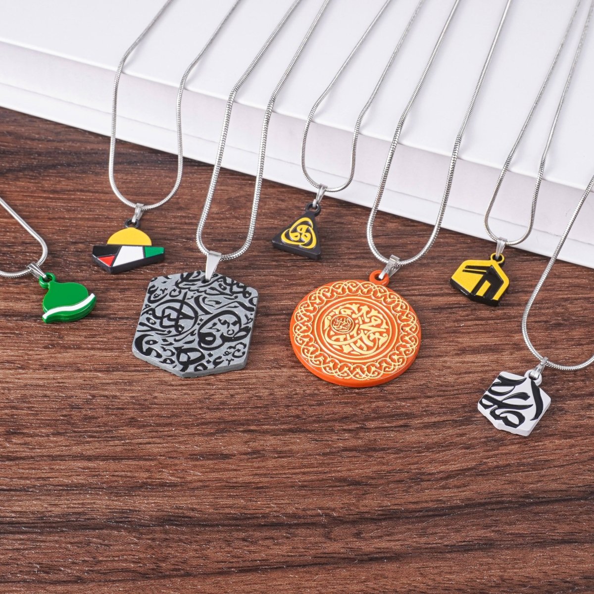 Discover the Islamic Geometric Pendants Collection — handcrafted-style charms with Arabic, Kaaba, and Palestine designs celebrating faith and identity.