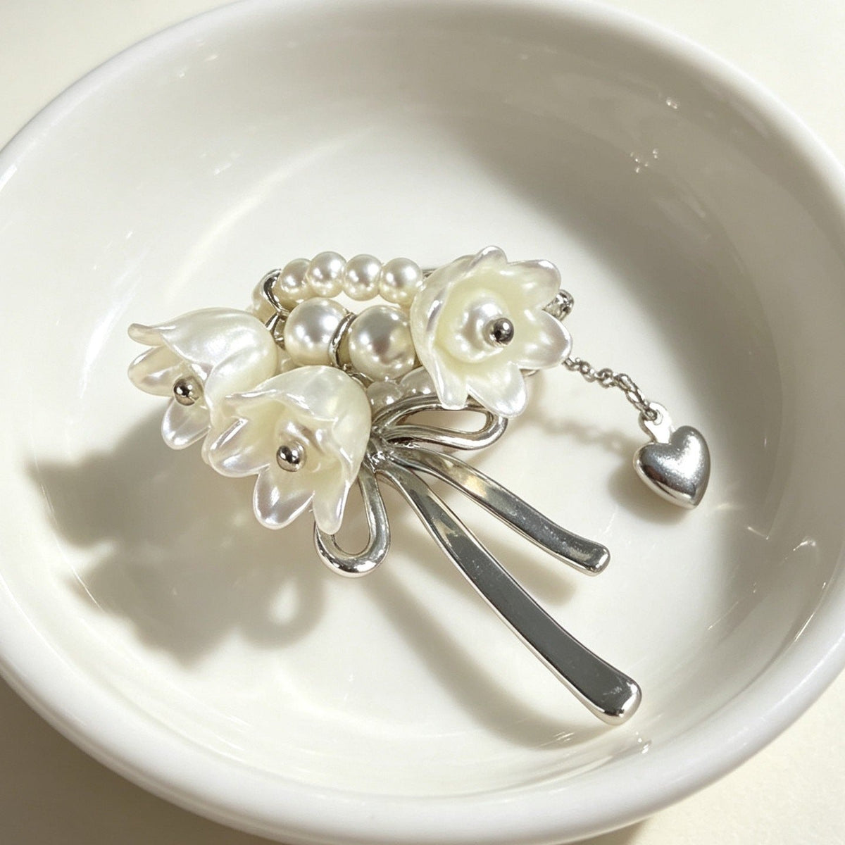 Front view of Lily of the Valley pearl bow ring showing floral cluster detail