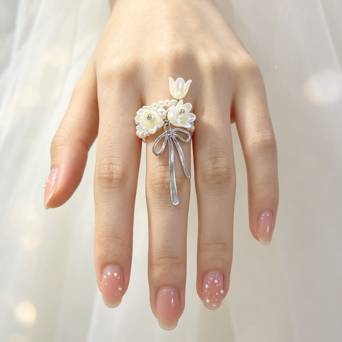 Flat-lay of Lily of the Valley ring alongside complementary modest fashion accessories