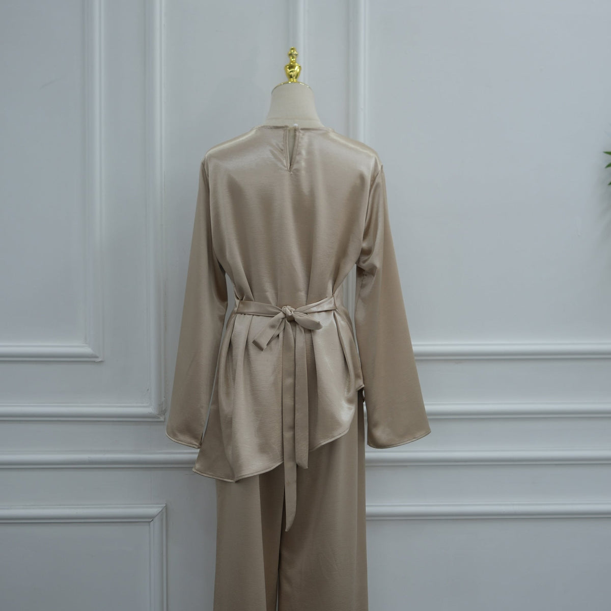 Side profile of modest two-piece showing longer back hem