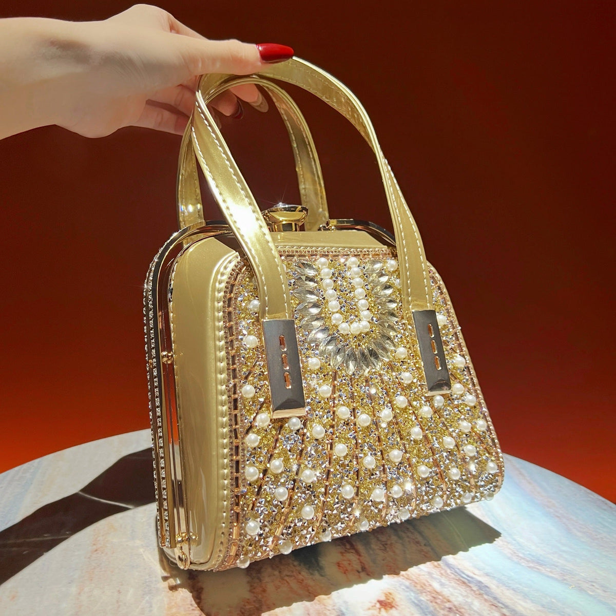 Side profile of pearl and rhinestone structured box clutch with chain strap