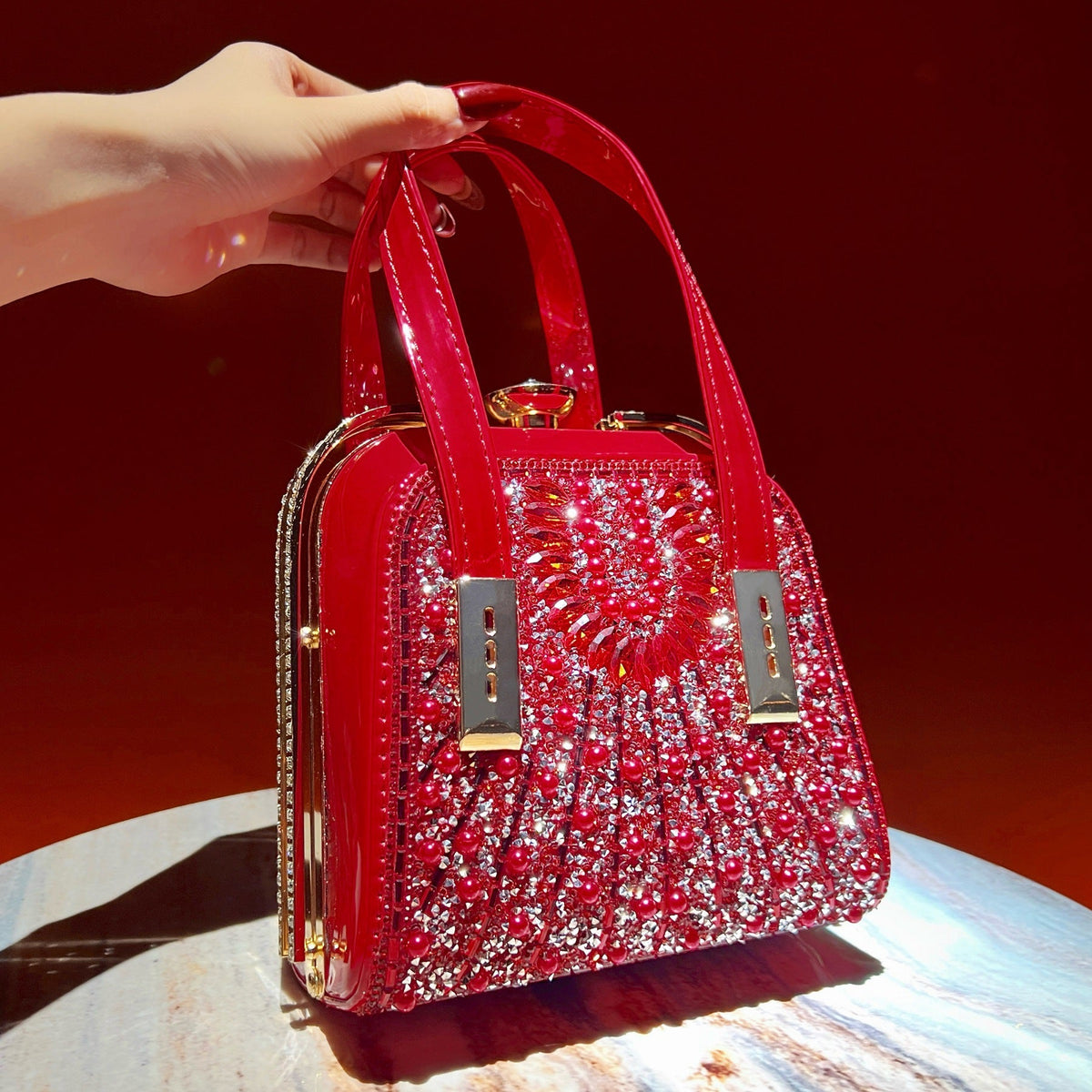 Crossbody styling of rhinestone evening bag worn over the shoulder with chain strap