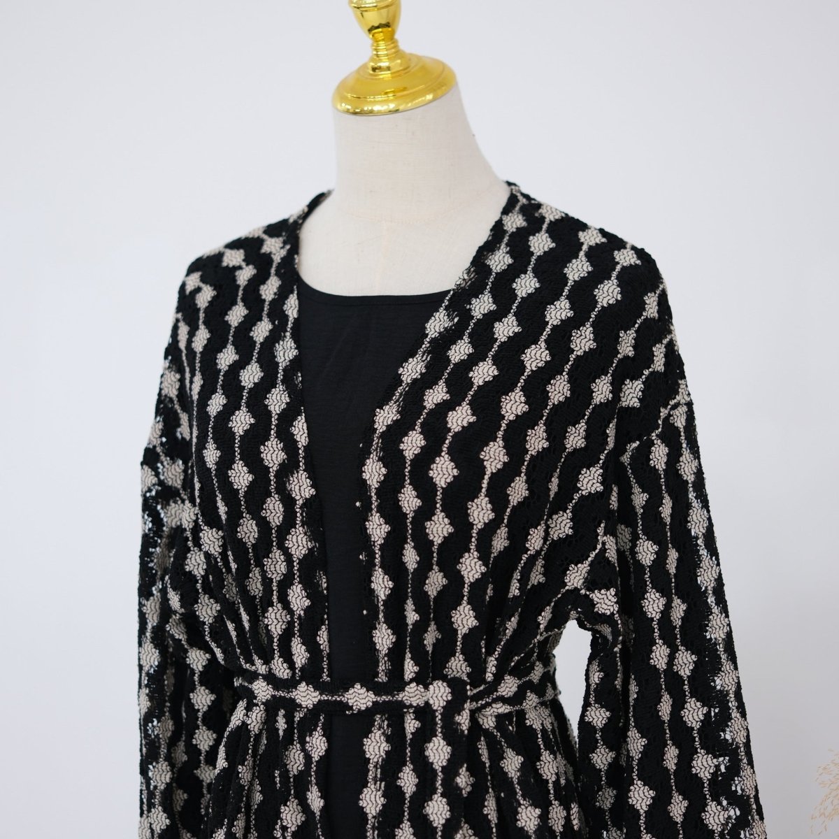 Close-up of scalloped lace edge along sleeve opening