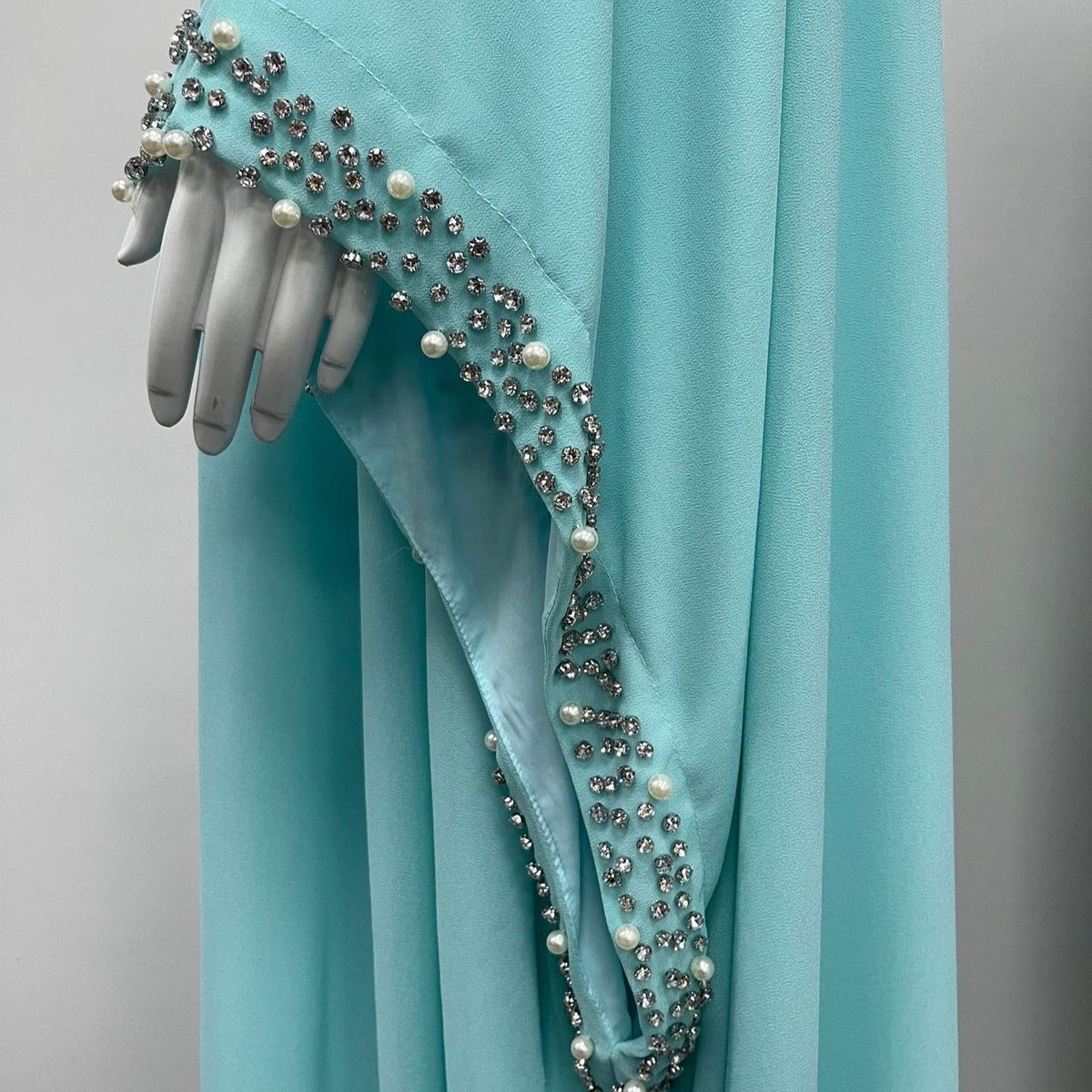 Ice blue colourway stand collar showing teal cabochon stones among pearl and rhinestone detail