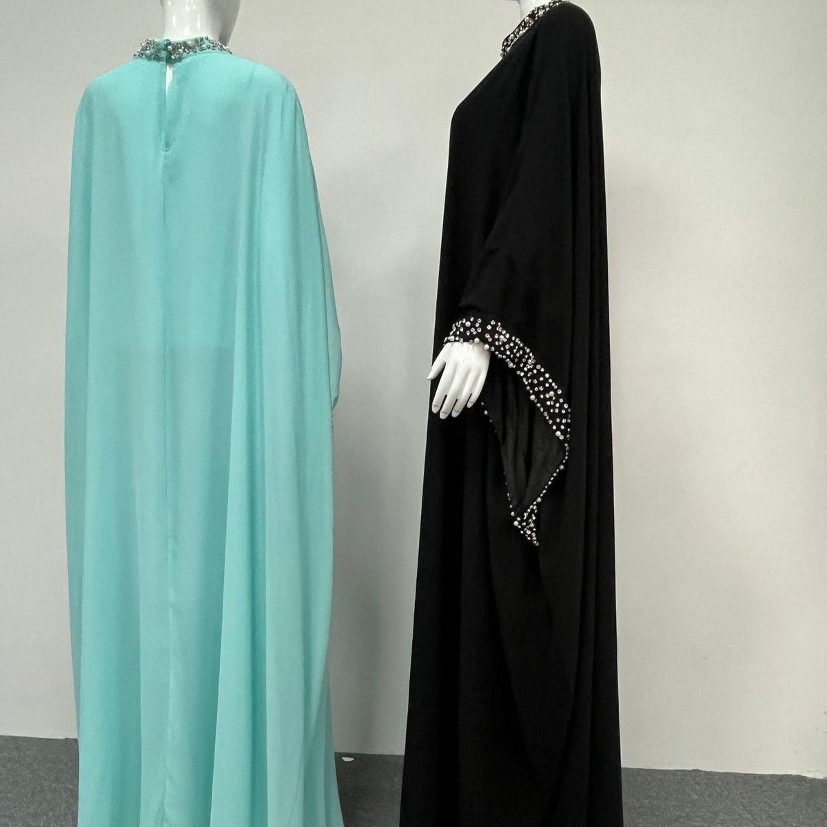 Wide batwing sleeve detail showing fluid semi-sheer fabric drape in motion
