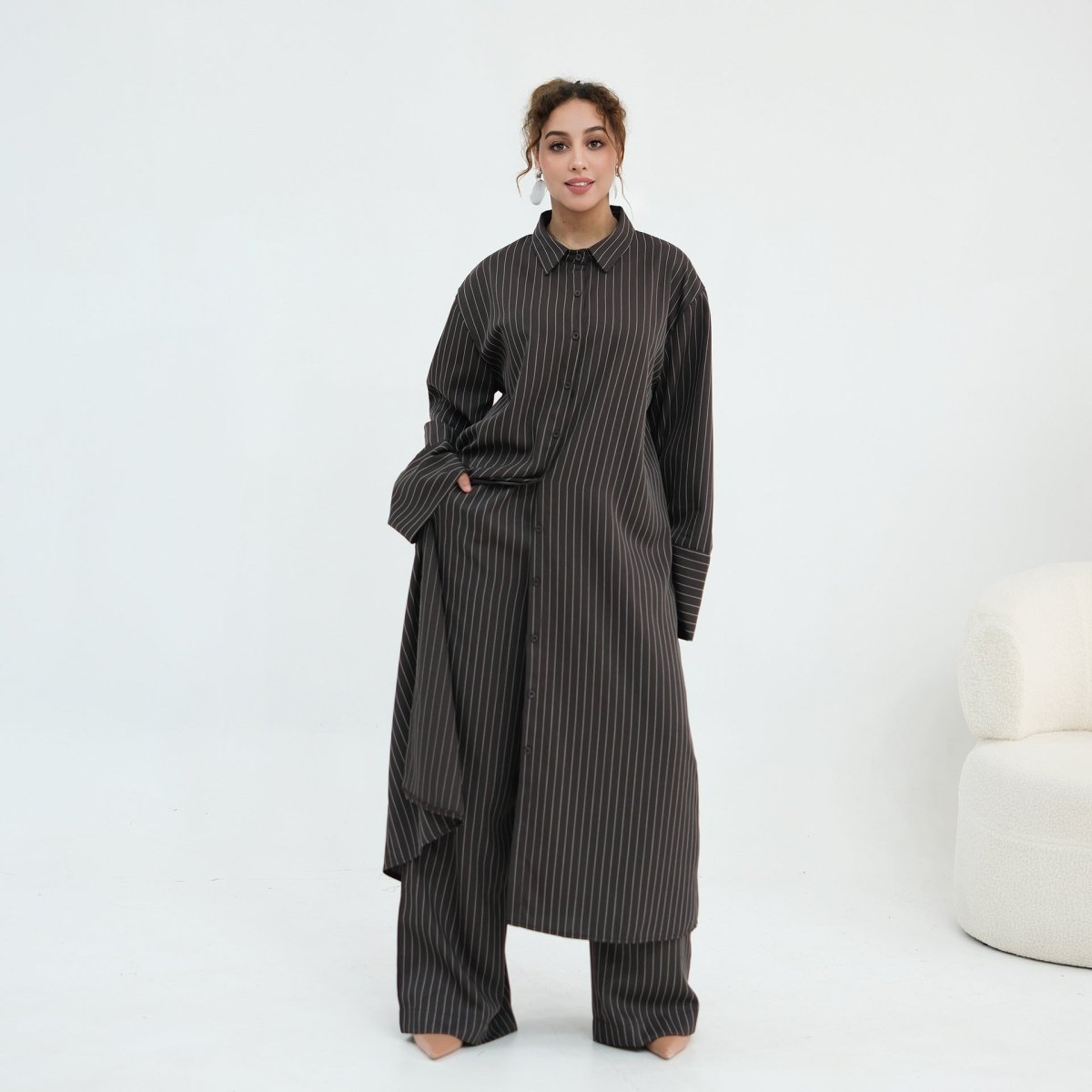 Relaxed straight-cut silhouette of the pinstripe wide-leg trousers from hip to hem
