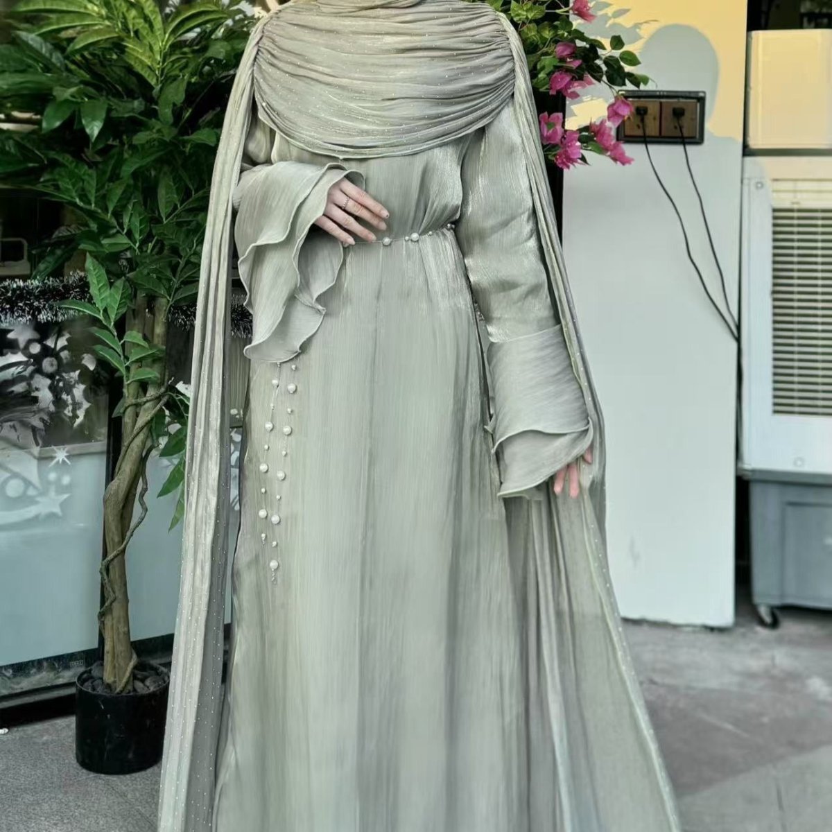 Back view of pleated abaya showing dramatic cape length