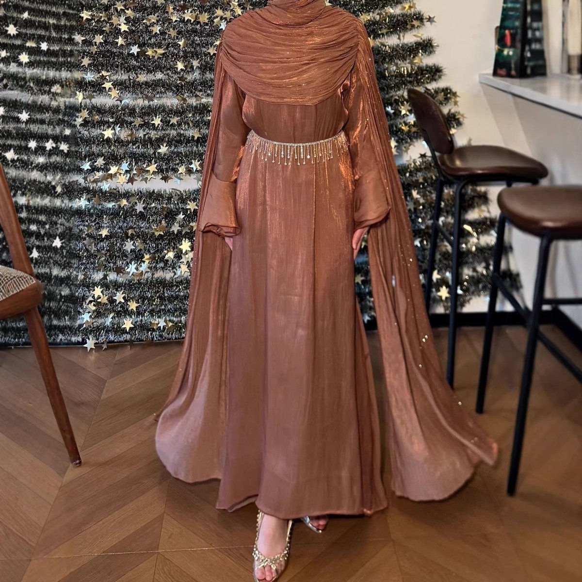 Back view of floor-length cape sleeve abaya showing sweeping sleeve panels