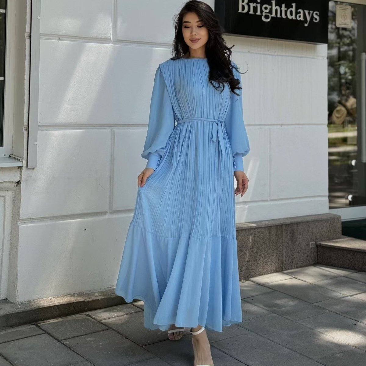 Three-quarter view of modest pleated abaya dress with lantern sleeve detail