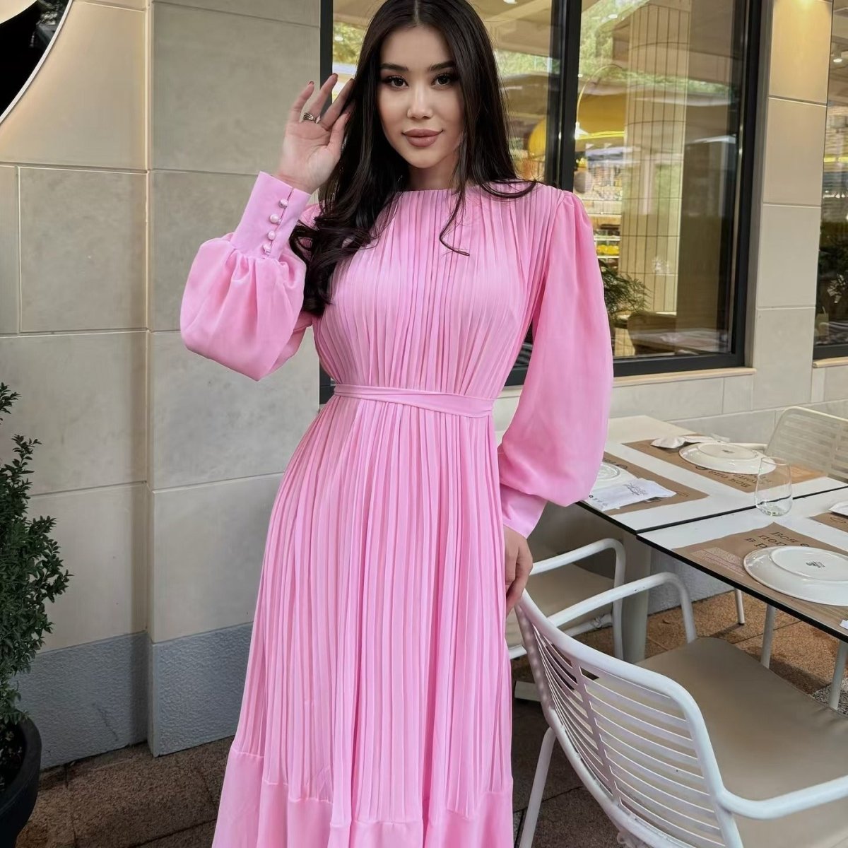 Back view of full-length modest pleated maxi dress with sweeping hem