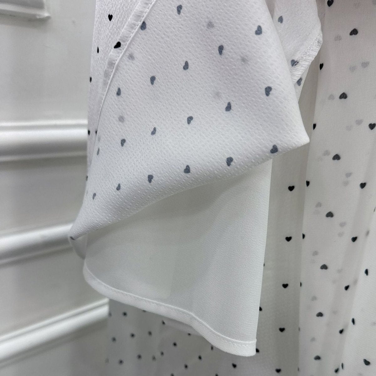 Printed open abaya and matching hijab set laid flat, showing both available prints
