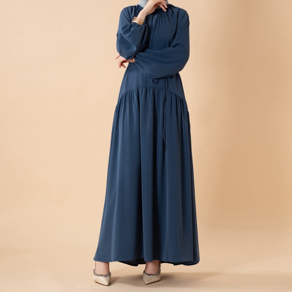 Pleated abaya flatlay showing complete 2-piece set with matching belt