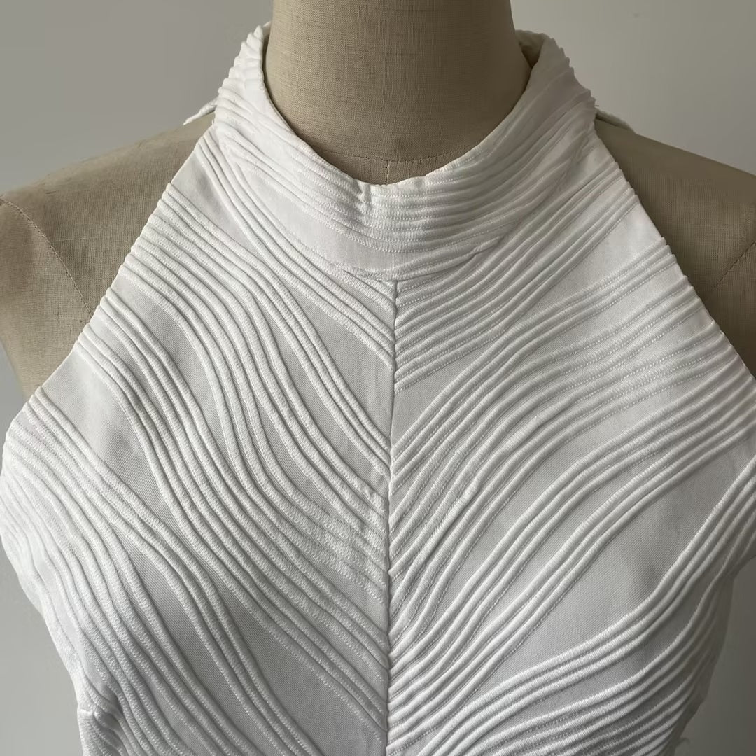 Close-up of chevron ribbed bodice and twisted knot waist on white gown