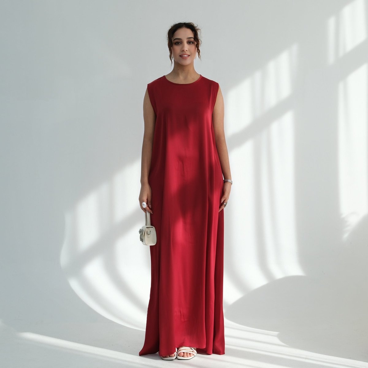 Full-length flat lay of sleeveless kaftan maxi dress showing fabric texture and colour options