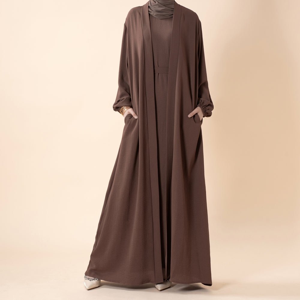 Open abaya worn open-front with sleeveless inner dress layered underneath