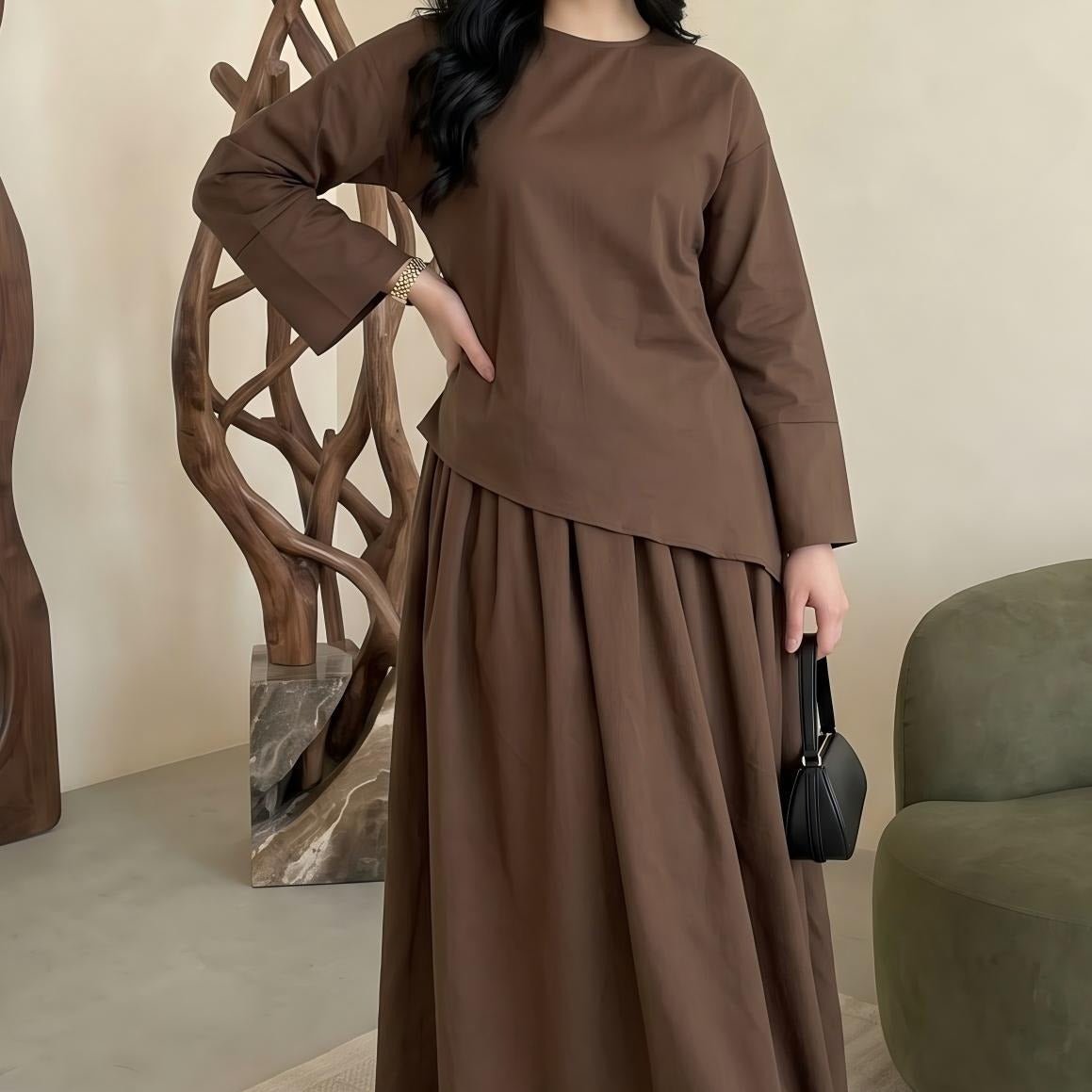 Detail of solid colour maxi skirt waistband and fabric fall