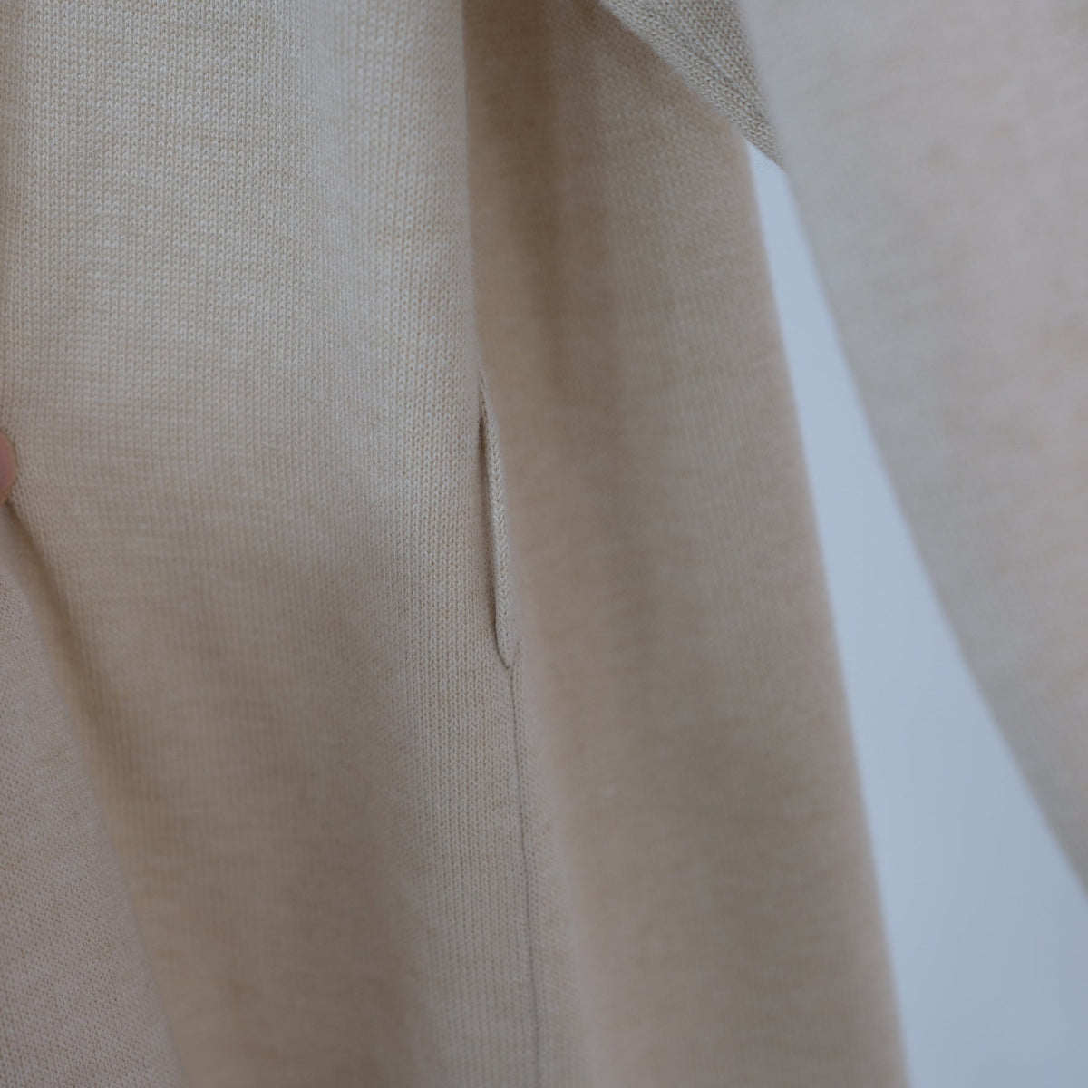 Close-up of waistband detail on knit trousers