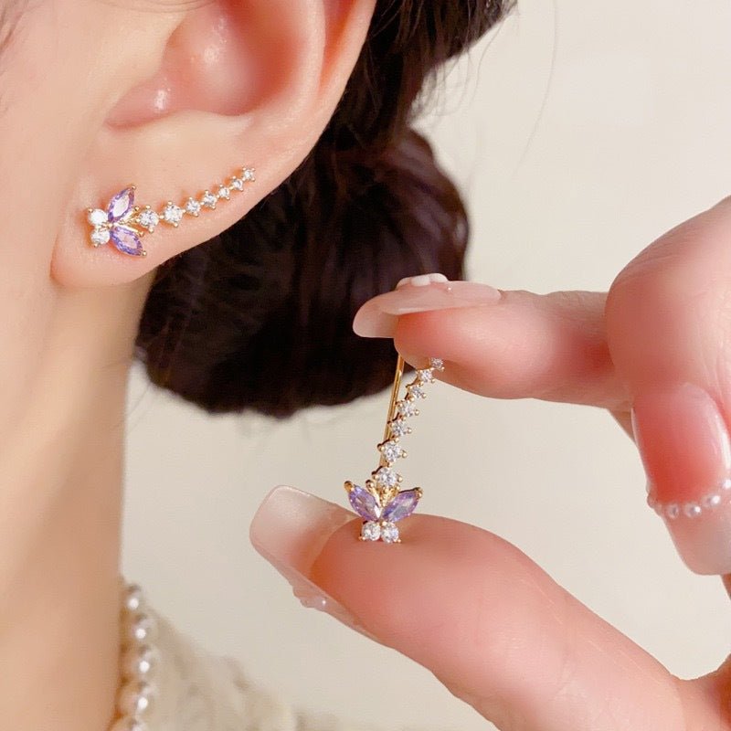 Ear crawler stacked with minimalist hoop earring on model