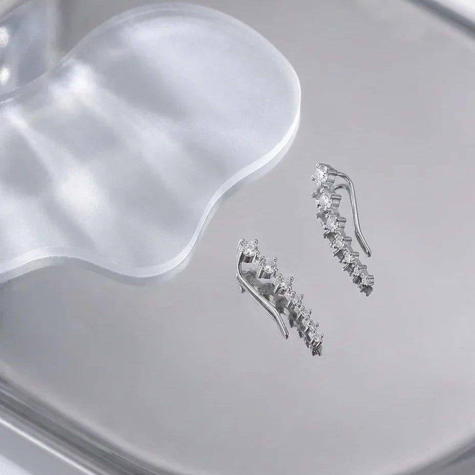Side profile showing crystal ear climber curving along earlobe